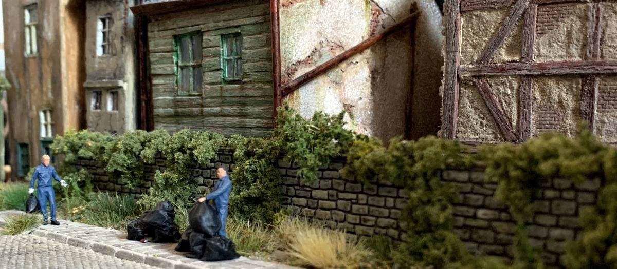 Alltagsszene in Kleinberge im Maßstab 1:87 mit Figuren, Mauer und alten Gebäuden